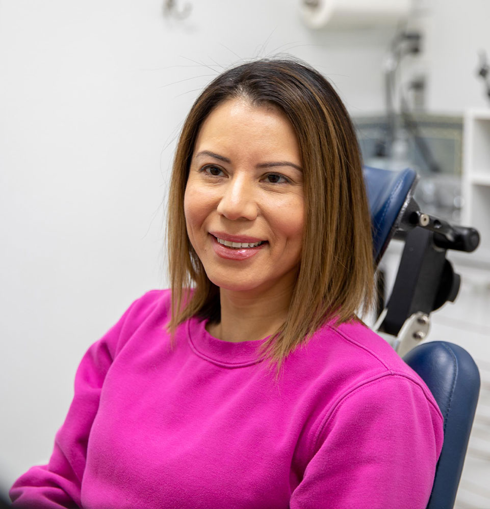 Patient smiling while going over dental information with doctor