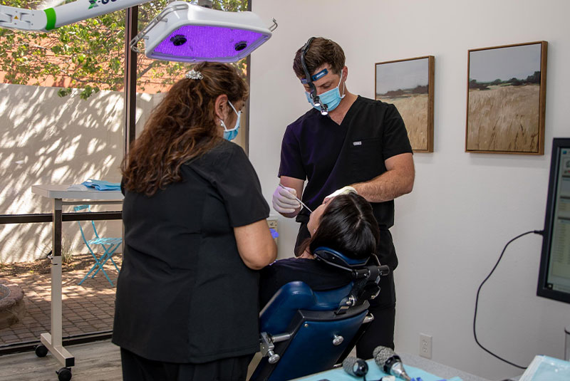 doctor and staff member performing guided dental procedure on patient
