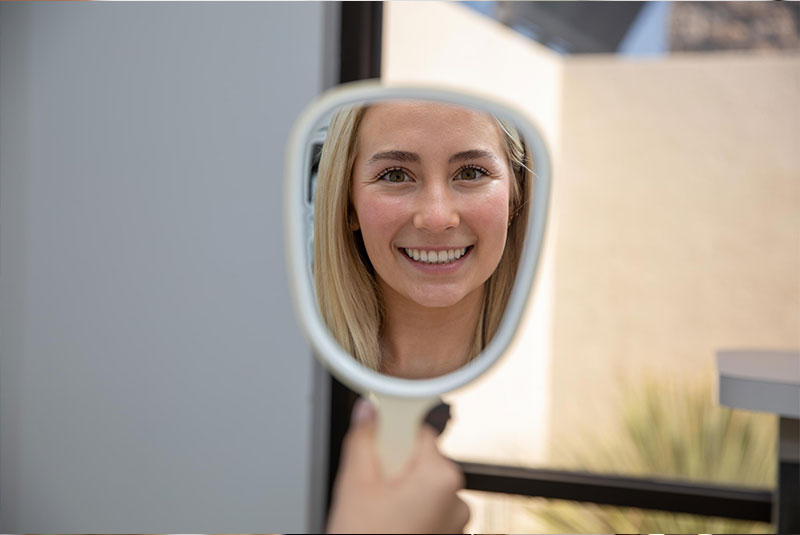 Patient smiling confidently after their dental procedure