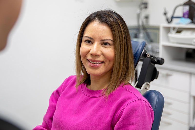 Patient smiling while going over dental procedure information